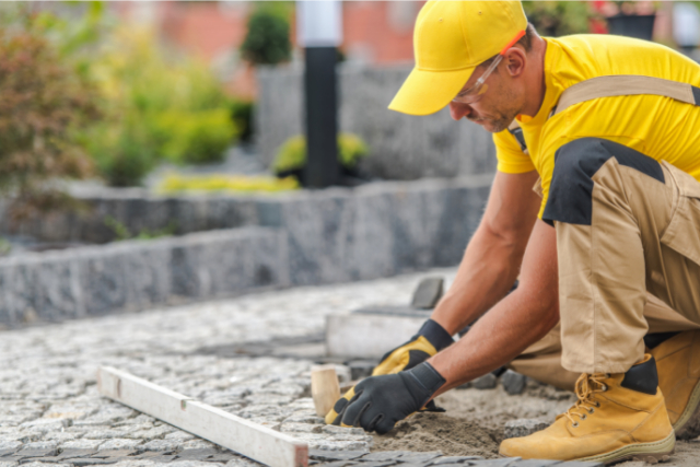 Worker Repairing the Pavement Road